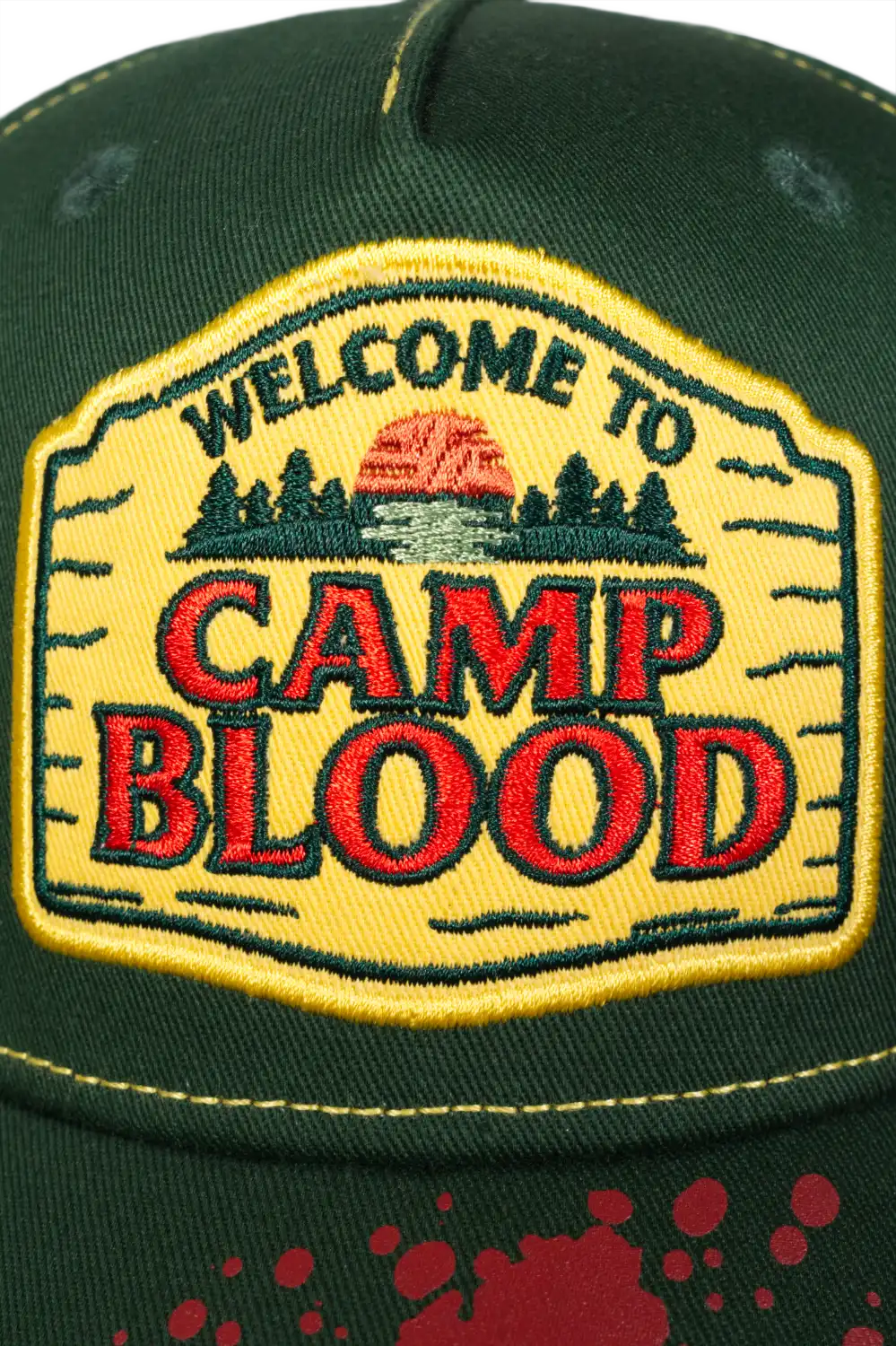 Close-up of embroidered “Camp Blood” patch on the front of a green horror baseball cap. inspired by Camp Crystal Lake