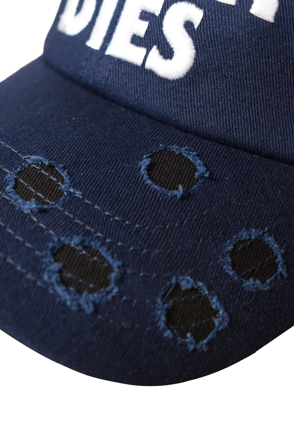 Close-up of bullet hole distressing on the brim of a navy horror baseball cap, inspired by Halloween