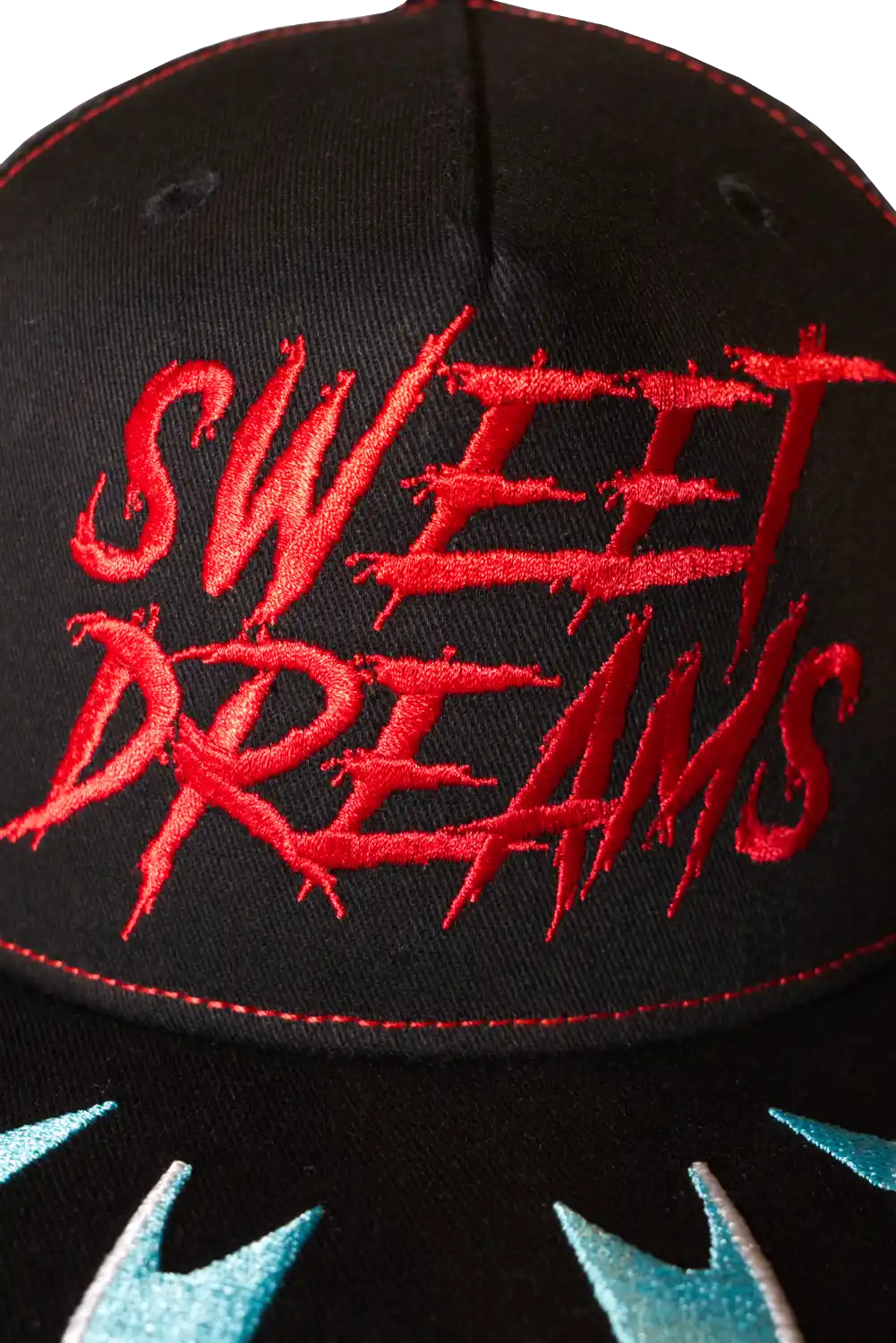 Close-up of red embroidered “Sweet Dreams” logo on black horror flat peak cap, inspired by Nightmare on elm street